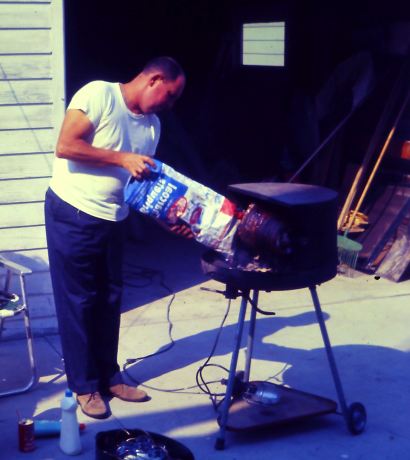 dad roasting a miami roll - add more charcoal